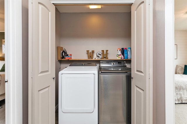 clothes washing area with washing machine and dryer and laundry area