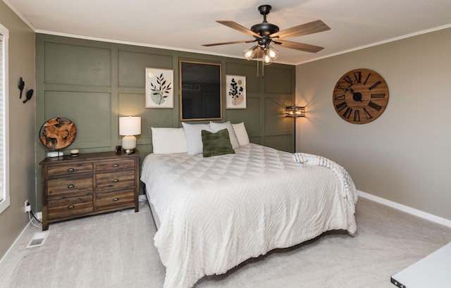 bedroom featuring carpet floors, visible vents, a decorative wall, and ornamental molding