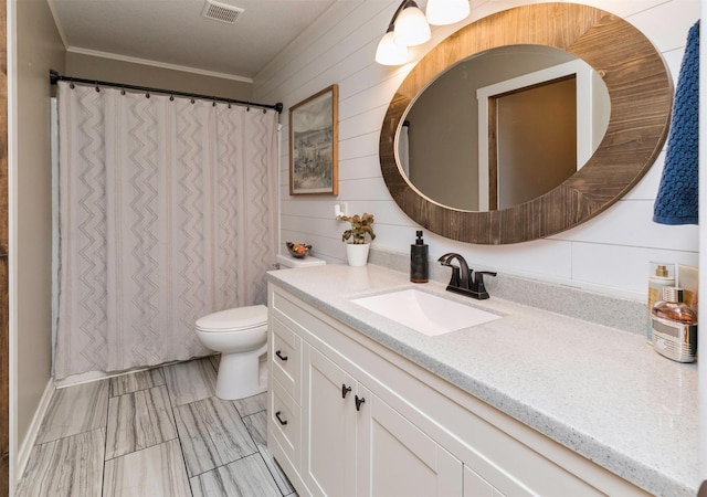 bathroom featuring visible vents, a shower with shower curtain, toilet, ornamental molding, and vanity