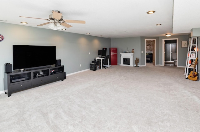 living area featuring a fireplace, baseboards, and carpet flooring