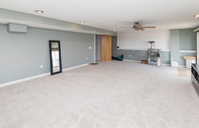 unfurnished living room with light carpet, ceiling fan, recessed lighting, and baseboards