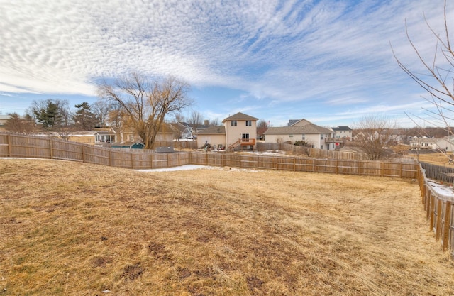 view of yard with a residential view and fence