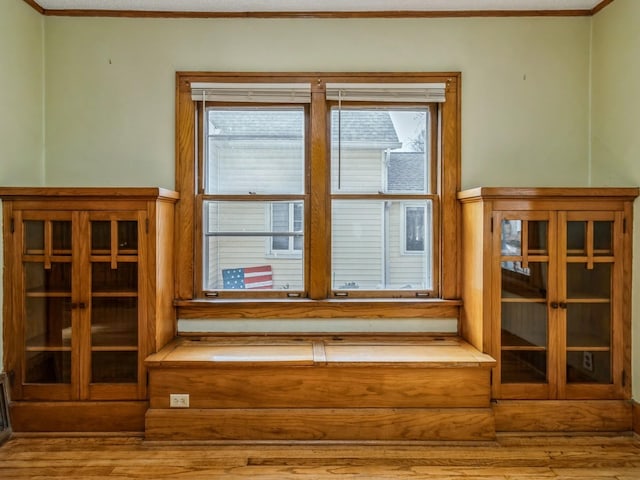 interior details featuring crown molding and wood finished floors