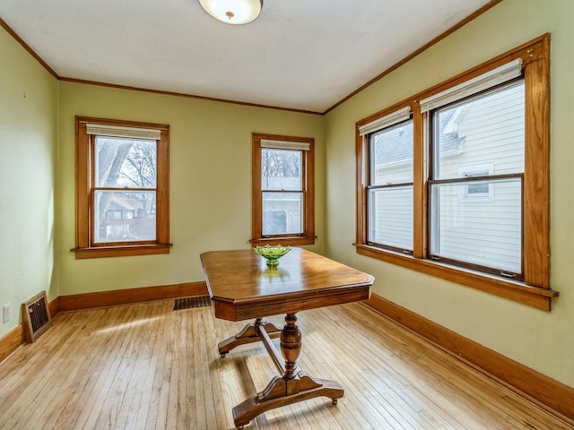 office space with light wood-type flooring, plenty of natural light, and baseboards