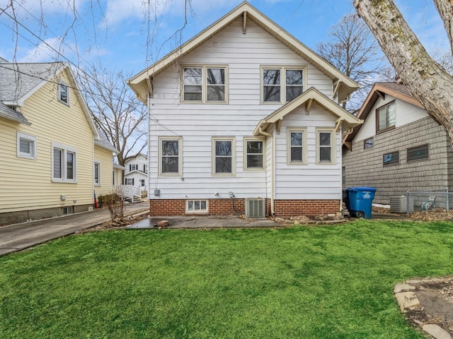 rear view of house with central air condition unit, a patio area, and a lawn