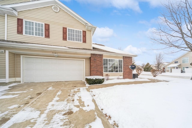 view of front facade with a garage, concrete driveway, and brick siding