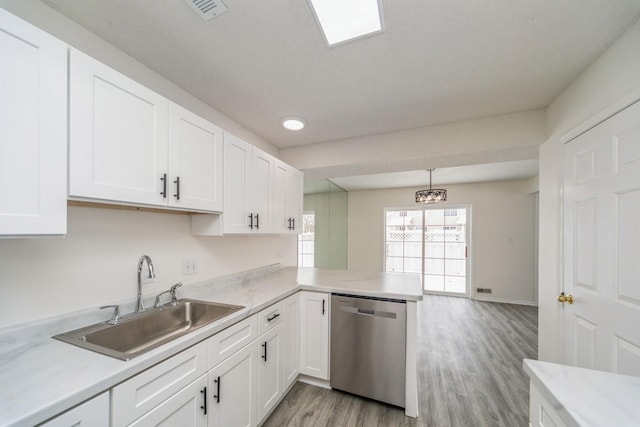 kitchen with a sink, white cabinetry, dishwasher, and decorative light fixtures