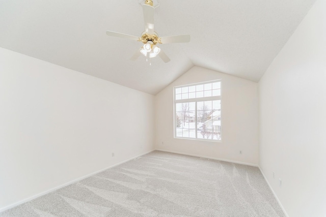 additional living space featuring lofted ceiling, ceiling fan, baseboards, and light colored carpet