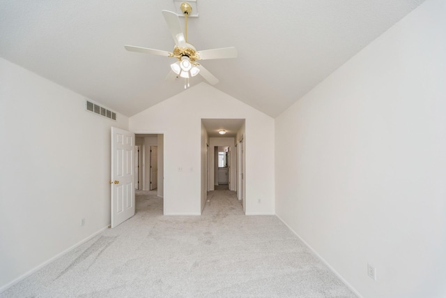 unfurnished bedroom featuring lofted ceiling, light carpet, a ceiling fan, visible vents, and baseboards