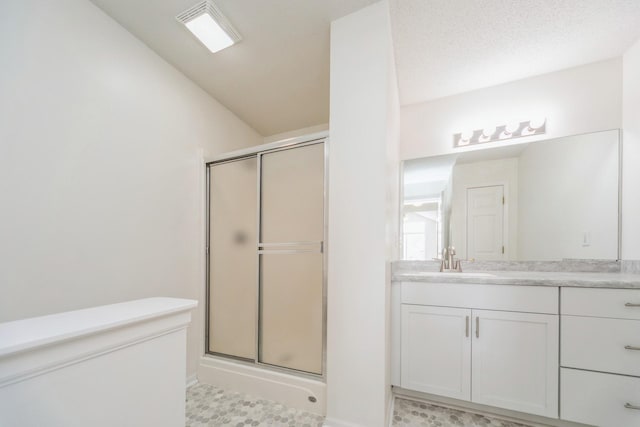 bathroom featuring a stall shower, visible vents, and vanity