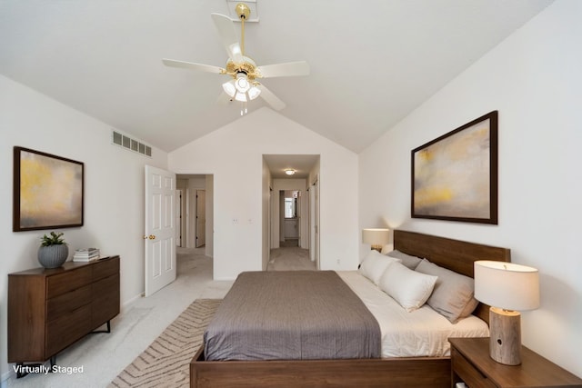 bedroom with visible vents, a ceiling fan, light carpet, connected bathroom, and vaulted ceiling