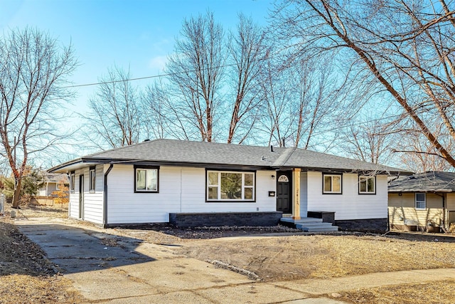 single story home with roof with shingles