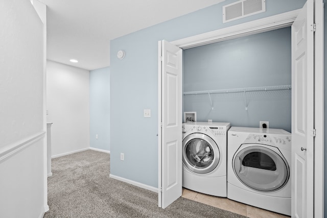 laundry area featuring light colored carpet, visible vents, laundry area, independent washer and dryer, and baseboards