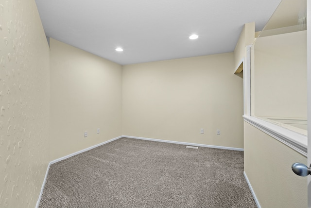 spare room with carpet floors, baseboards, and recessed lighting