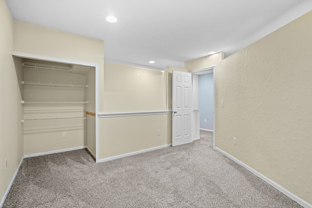 unfurnished bedroom featuring carpet, a closet, and baseboards