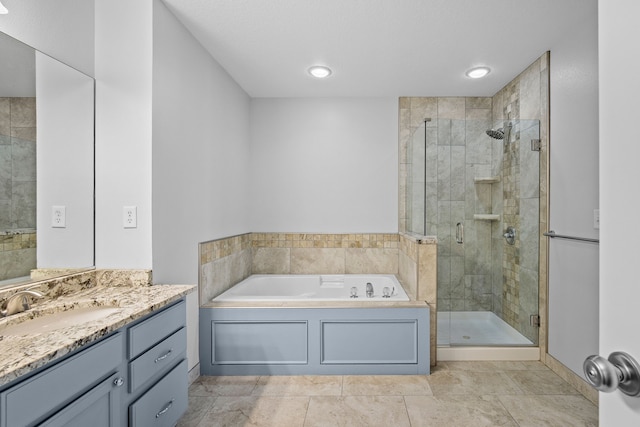 full bath featuring a shower stall, vanity, and a bath