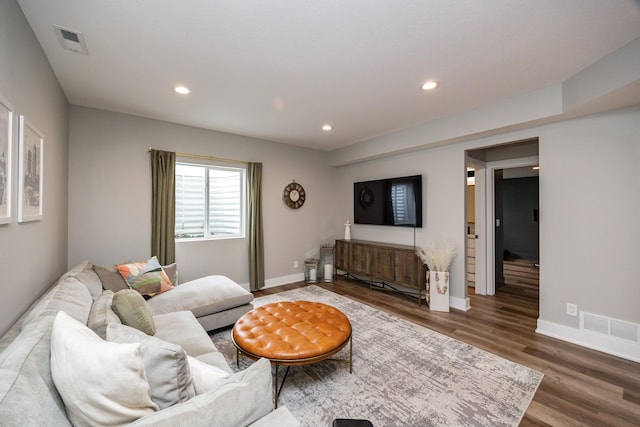 living area with baseboards, dark wood finished floors, visible vents, and recessed lighting