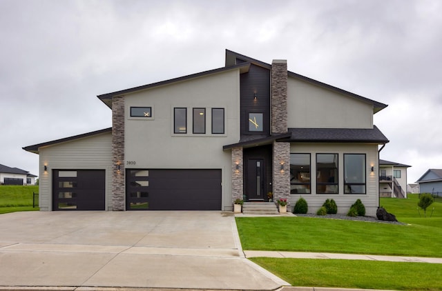 contemporary home featuring driveway, a front lawn, stone siding, and stucco siding