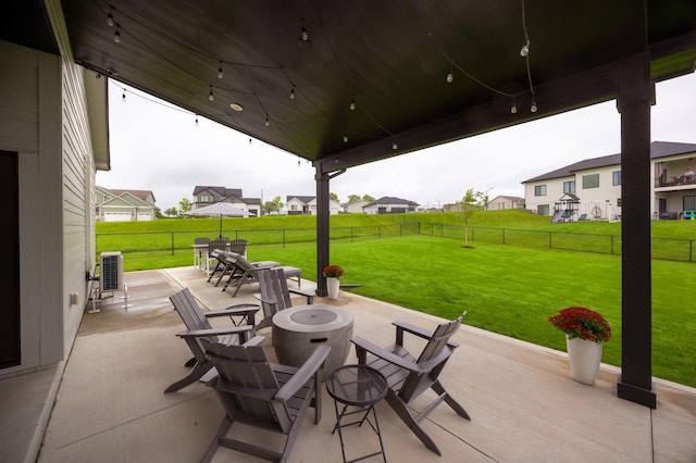 view of patio / terrace featuring an outdoor fire pit, a residential view, outdoor dining area, and a fenced backyard