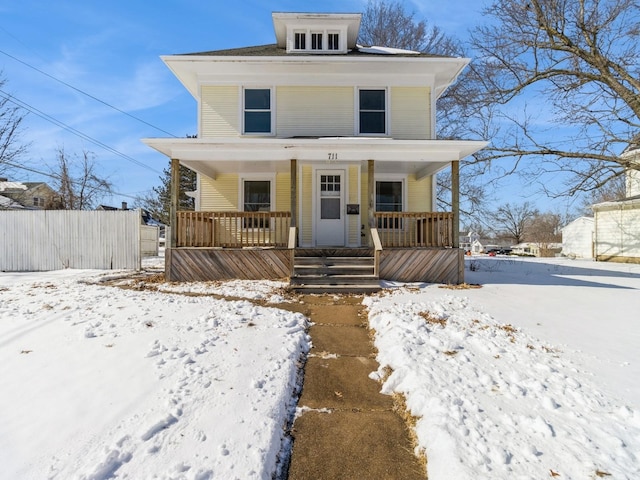 traditional style home with fence and a porch