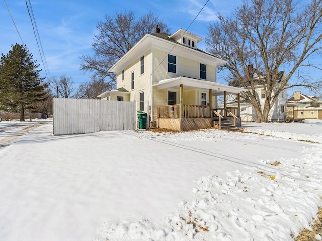 view of front of property with a porch and fence