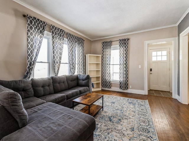 living room featuring baseboards, crown molding, and hardwood / wood-style floors