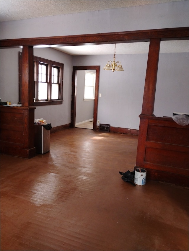 interior space featuring wood finished floors, visible vents, and baseboards