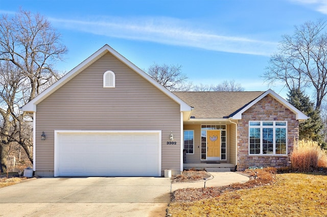 single story home featuring an attached garage, stone siding, roof with shingles, and concrete driveway