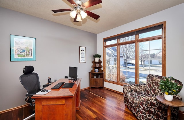 home office with a textured ceiling, dark wood finished floors, and baseboards