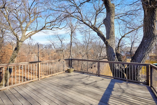 wooden terrace with a view of trees