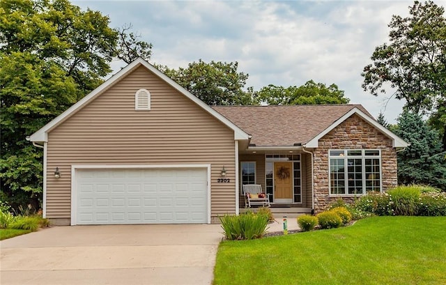 ranch-style home featuring roof with shingles, concrete driveway, a front yard, a garage, and stone siding