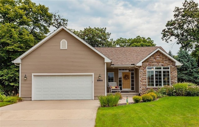 3302 SW Edgewood Ln, Ankeny, IA 50023 - single story home featuring driveway, a front yard, stone siding, a garage, and covered porch
