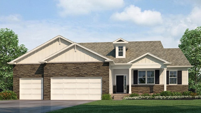 craftsman-style house featuring board and batten siding, a front yard, stone siding, and a garage