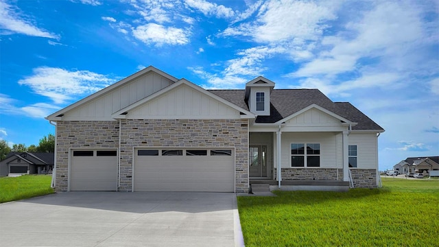 650 NW Concord Ln, Waukee, IA 50263 - craftsman house featuring stone siding, board and batten siding, driveway, a front yard, and an attached garage
