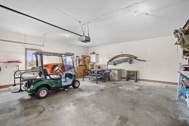 garage with baseboards and a garage door opener