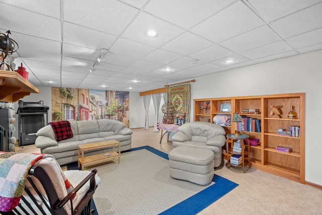 living area featuring a paneled ceiling, a fireplace, and recessed lighting