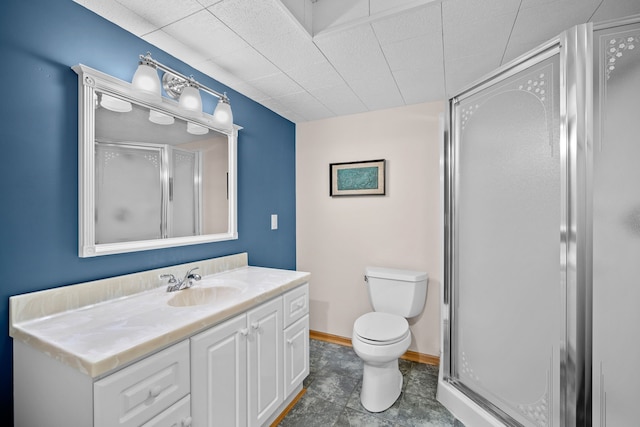 full bathroom featuring baseboards, a shower stall, toilet, and vanity