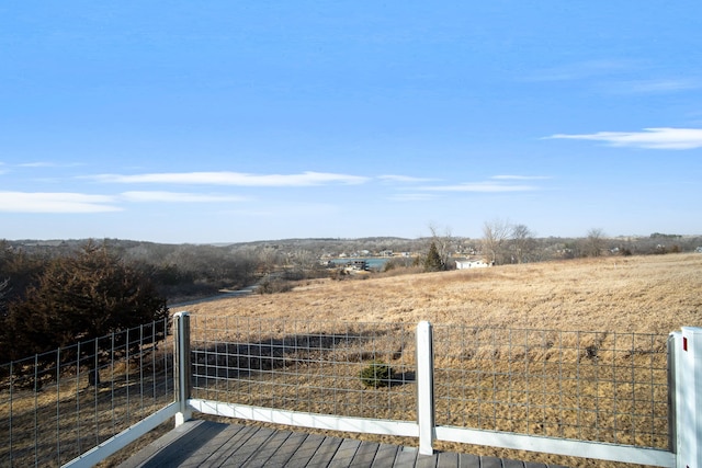 view of yard featuring a rural view and fence