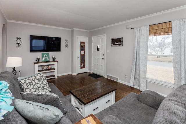 living room with dark wood-style floors, a healthy amount of sunlight, and visible vents