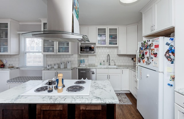 kitchen featuring appliances with stainless steel finishes, white cabinets, a sink, and island range hood