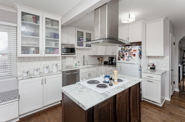 kitchen with island exhaust hood, white cabinetry, stainless steel appliances, and a sink