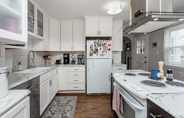 kitchen with white appliances, ventilation hood, a sink, and white cabinets