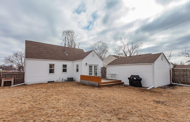 back of property featuring french doors, roof with shingles, a yard, fence, and a deck