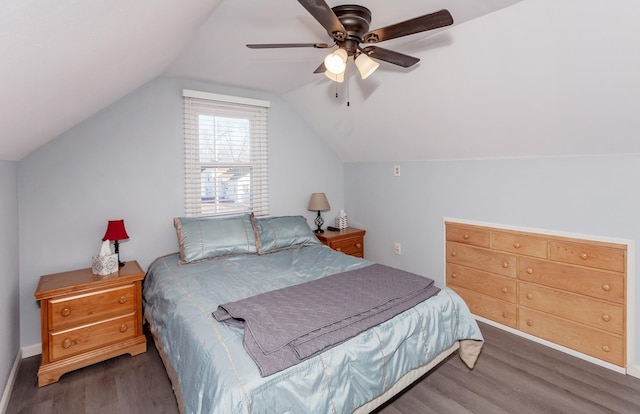 bedroom with a ceiling fan, vaulted ceiling, and wood finished floors