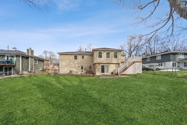 back of house featuring a yard, fence, stairway, and a wooden deck