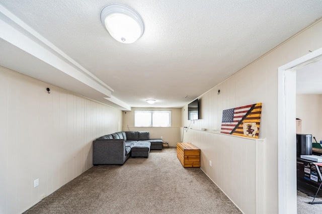 living room featuring light colored carpet and a textured ceiling