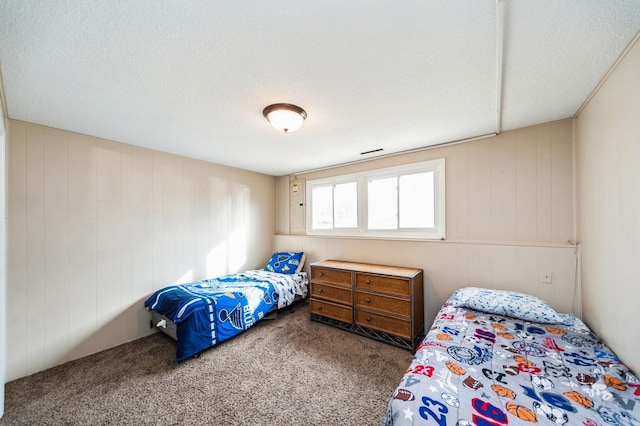 carpeted bedroom with a textured ceiling