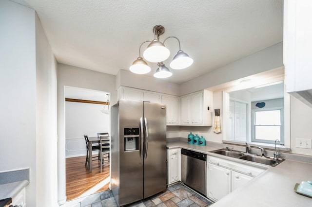 kitchen featuring stainless steel appliances, light countertops, and white cabinetry