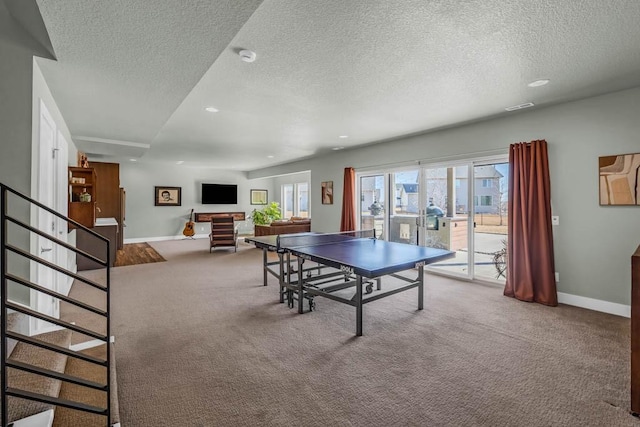 playroom with a textured ceiling, baseboards, carpet flooring, and french doors