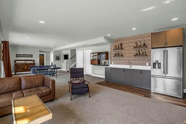 living room featuring visible vents, baseboards, stairway, dark carpet, and recessed lighting